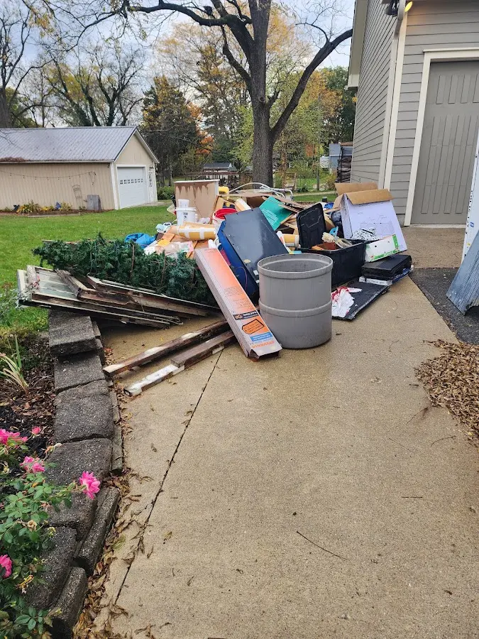 Dumpster being loaded with debris for 12 Yard Dumpster Rental in Buenaventura Lakes